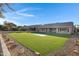 Artificial turf backyard with rock landscaping and a large patio at 19039 N 90Th Ln, Peoria, AZ 85382