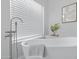 Relaxing bathroom with a modern freestanding bathtub and a large window at 19039 N 90Th Ln, Peoria, AZ 85382