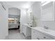 Bright bathroom with double vanity and a view into the bedroom at 19039 N 90Th Ln, Peoria, AZ 85382
