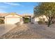 Single-story home with a two-car garage and desert landscaping at 19039 N 90Th Ln, Peoria, AZ 85382
