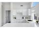 Bright kitchen features white cabinets, quartz countertops, and a large window at 19039 N 90Th Ln, Peoria, AZ 85382