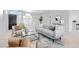 Bright living room featuring a neutral color palette and modern furniture at 19039 N 90Th Ln, Peoria, AZ 85382