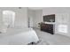 Main bedroom with plush carpet, large TV, and access to bathroom at 19039 N 90Th Ln, Peoria, AZ 85382