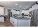 Spacious kitchen with white cabinets, granite countertops, and stainless steel appliances at 26203 N 50Th Dr, Phoenix, AZ 85083