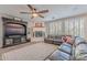 Living room features a fireplace, sectional sofa, and large TV at 26203 N 50Th Dr, Phoenix, AZ 85083