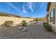 Spacious backyard with gravel and drought-tolerant plants at 27046 W Yukon Dr, Buckeye, AZ 85396