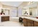 Elegant bathroom with double vanity and large soaking tub at 27046 W Yukon Dr, Buckeye, AZ 85396
