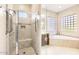 Bathroom with a walk-in shower and a separate soaking tub at 27046 W Yukon Dr, Buckeye, AZ 85396