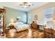 Guest bedroom with hardwood floors and ceiling fan at 27046 W Yukon Dr, Buckeye, AZ 85396