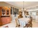 Charming dining area with a wood table and chairs, and a wine rack at 27046 W Yukon Dr, Buckeye, AZ 85396