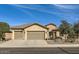Beautiful desert landscape surrounds this single-story home with a three-car garage at 27046 W Yukon Dr, Buckeye, AZ 85396