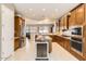 Island kitchen features stainless steel appliances and ample storage at 27046 W Yukon Dr, Buckeye, AZ 85396