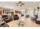 Open living room and kitchen with hardwood floors and a cozy fireplace at 27046 W Yukon Dr, Buckeye, AZ 85396