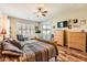 Main bedroom with hardwood floors, a ceiling fan, and access to backyard at 27046 W Yukon Dr, Buckeye, AZ 85396