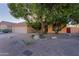 House with a two-car garage and mature trees in the front yard at 3846 N Kings Peak --, Mesa, AZ 85215
