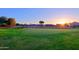 Scenic golf course view at sunset with homes in the background at 3846 N Kings Peak --, Mesa, AZ 85215