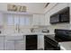 White kitchen with farmhouse sink, gas range and microwave at 3846 N Kings Peak --, Mesa, AZ 85215