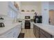 Modern kitchen with white cabinets, quartz countertops, and black appliances at 3846 N Kings Peak --, Mesa, AZ 85215