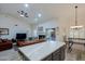 Kitchen island overlooks living room with fireplace and patio access at 3846 N Kings Peak --, Mesa, AZ 85215
