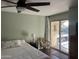 Bedroom with a king bed, balcony access, and ample natural light at 4727 E Lafayette Blvd # 319, Phoenix, AZ 85018