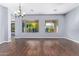 Dining room with hardwood floors, large windows, and a chandelier at 5011 W Yoosooni Dr, Phoenix, AZ 85087