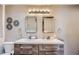 Clean bathroom with double sinks and modern wood cabinets at 8310 E Devonshire Ave, Scottsdale, AZ 85251