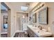 Updated bathroom with double sinks, shower, and stylish tile at 8310 E Devonshire Ave, Scottsdale, AZ 85251