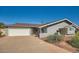 Gray block home with a neatly landscaped front yard and attached garage at 8310 E Devonshire Ave, Scottsdale, AZ 85251