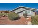 Gray block home with mature shrubs and a rock garden at 8310 E Devonshire Ave, Scottsdale, AZ 85251
