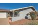 Side view of a gray block home with a walkway and landscaping at 8310 E Devonshire Ave, Scottsdale, AZ 85251
