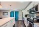 Modern kitchen with white cabinets, stainless steel appliances, and an island at 8310 E Devonshire Ave, Scottsdale, AZ 85251