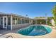 Kidney shaped pool with a large patio and a pergola at 8310 E Devonshire Ave, Scottsdale, AZ 85251