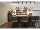 Wet bar with an assortment of liquors and glasses at 1044 W Indian Hills Pl, Phoenix, AZ 85023
