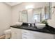 Modern bathroom with double sinks and dark countertop at 1044 W Indian Hills Pl, Phoenix, AZ 85023