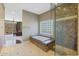 Spa-like bathroom with a soaking tub, walk-in shower, and large window at 1044 W Indian Hills Pl, Phoenix, AZ 85023