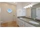 Bathroom boasts double sinks, granite countertops, and a large mirror at 1044 W Indian Hills Pl, Phoenix, AZ 85023