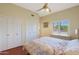 Bedroom with wood floors, window shutters, and ample closet space at 1044 W Indian Hills Pl, Phoenix, AZ 85023