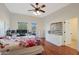 Main bedroom with wood floors, a ceiling fan and private access to a deck at 1044 W Indian Hills Pl, Phoenix, AZ 85023