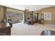 Large bedroom with a four poster bed and access to a patio at 1044 W Indian Hills Pl, Phoenix, AZ 85023