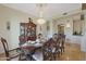 Elegant formal dining room with a large wood table, chandelier, and antique china cabinet at 1044 W Indian Hills Pl, Phoenix, AZ 85023