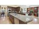 Open kitchen with island, stainless steel appliances and views to Gathering room at 1044 W Indian Hills Pl, Phoenix, AZ 85023