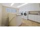Laundry room with white cabinets, granite countertops, and a washer and dryer at 1044 W Indian Hills Pl, Phoenix, AZ 85023
