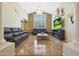 Spacious living room featuring a large TV, comfortable leather sofas, and a high ceiling at 1044 W Indian Hills Pl, Phoenix, AZ 85023