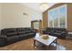 Relaxing living room with leather sofas, a coffee table, and views to the kitchen at 1044 W Indian Hills Pl, Phoenix, AZ 85023