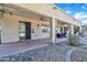 Covered patio with tile flooring, ceiling fans, and comfortable seating area at 14462 W Avalon Dr, Goodyear, AZ 85395