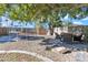 Relaxing backyard space with patio furniture under a large tree at 14462 W Avalon Dr, Goodyear, AZ 85395