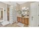 Elegant bathroom with a glass block shower and dual sinks at 14462 W Avalon Dr, Goodyear, AZ 85395
