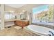 Primary bathroom with soaking tub and dual vanity at 14462 W Avalon Dr, Goodyear, AZ 85395