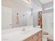 Bathroom with wood cabinets and colorful shower curtain at 14462 W Avalon Dr, Goodyear, AZ 85395