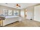 Bright bedroom featuring a ceiling fan and large windows at 14462 W Avalon Dr, Goodyear, AZ 85395